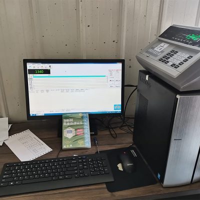 Digital weighbridge indicator connected to a PC for precise data logging and inventory management in Nigeria.